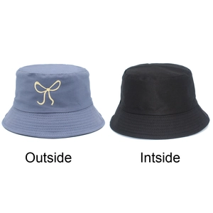 Dual-sided bucket hat with bow embroidery in misty blue and solid black for sun protection