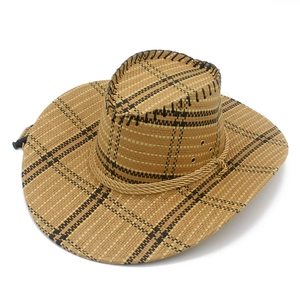 Detail view of woven straw cowboy hat featuring check pattern and adjustable chin cord