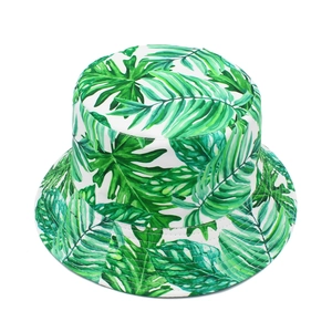 Detail of tropical palm leaf print and reinforced stitching on white bucket sun hat
