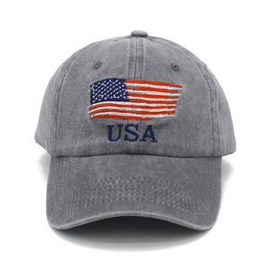 Close-up of USA embroidery and flag on washed dark grey cotton baseball cap detail