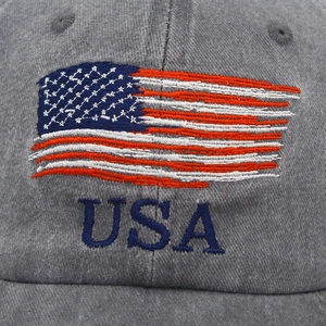 Close-up of embroidered USA logo and American flag on grey washed cotton baseball cap