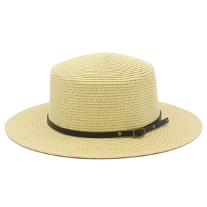 Close-up of flat-top straw boater hat featuring a brown leather band and metal buckle detail