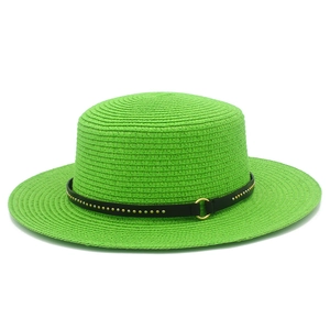 Detail of bright green straw hat featuring black leather band with golden metal rivets