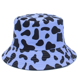 Unisex light blue bucket hat with black cow print and stitched brim for sun protection