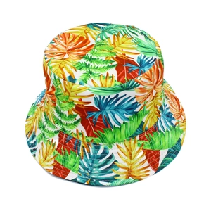 Detailed close-up of vibrant tropical leaf patterns on a foldable summer sun bucket hat