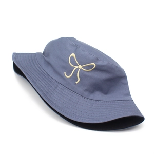 Detailed embroidery of a pale yellow bow on a high-quality grey-blue cotton bucket hat