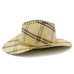 Close-up of woven straw cowboy hat featuring brown check pattern and metal eyelets