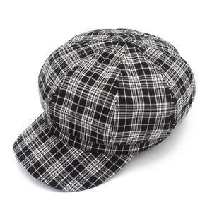 Détail de la texture du tissu et du motif pied-de-poule d'une casquette gavroche vintage