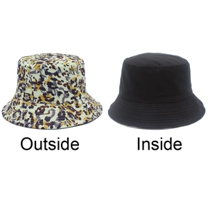 Dual-sided bucket hat featuring leopard print outside and solid black design inside