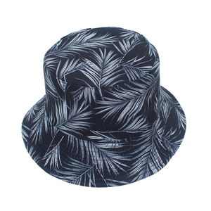Close-up detail of the black and white palm leaf pattern on the foldable cotton bucket hat