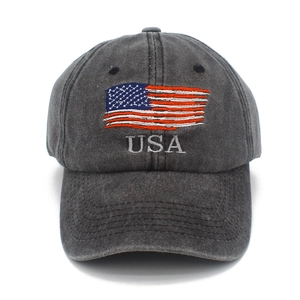 Close-up detail of USA embroidery and flag on distressed washed grey cotton baseball cap