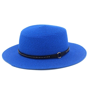 Detail of blue straw sun hat featuring black leather band and gold metal studs