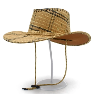 Detail of woven straw cowboy hat with metallic eyelets and adjustable chin strap