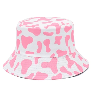Summer casual bucket hat featuring a sweet pink and white cow print pattern for sun protection