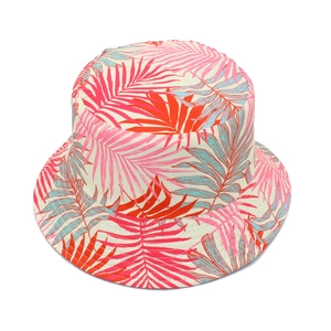 Detailed view of women's bucket hat with colorful tropical leaf print on cotton fabric