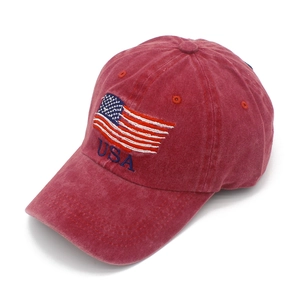 Detail of USA flag embroidery and vintage washed red cotton texture on baseball cap