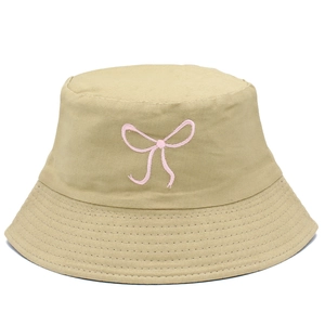 Close-up of khaki cotton bucket hat featuring pink bow embroidery and stitched brim
