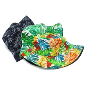 Detail of tropical leaf prints on foldable canvas bucket hats in three colorways