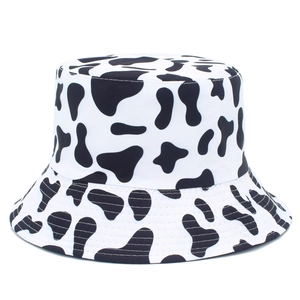 Detail of reinforced stitching and cow print fabric on a casual bucket hat for sun protection