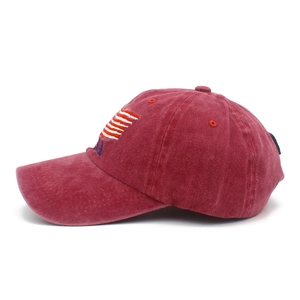 Detail of USA embroidery and flag on distressed washed burgundy cotton baseball cap