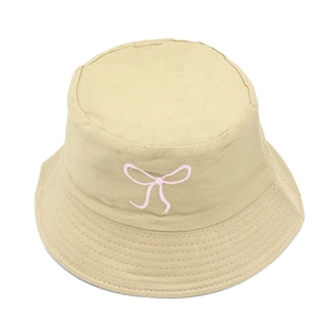 Close-up of pink bow embroidery and durable stitching on a beige cotton bucket hat