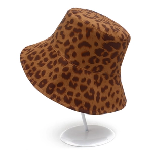 Close-up of leopard print sun hat fabric texture on a white display stand