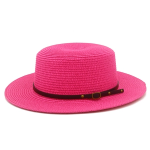 Detail of fuchsia boater hat weave with brown leather band and metallic rivet buckle