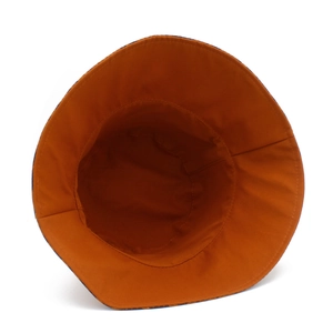 Detailed view of the orange cotton lining and neat stitching inside the bucket hat