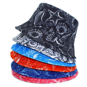 Close-up of ocean-themed prints featuring starfish and shells on cotton bucket hats