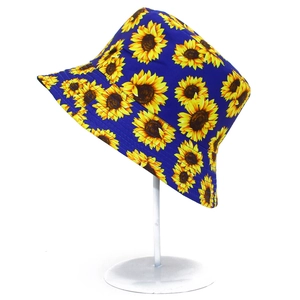Detailed close-up of a navy blue bucket hat with vibrant yellow sunflower patterns