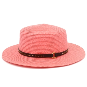 Detail of coral pink boater hat with dark brown leather belt and golden buckle