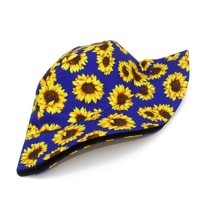 Close-up of yellow sunflower pattern on navy blue cotton fisherman hat with fine stitching