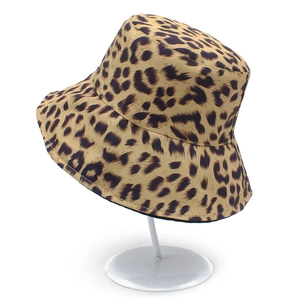 Detailed view of fashionable leopard print bucket hat on a display stand for summer sun protection