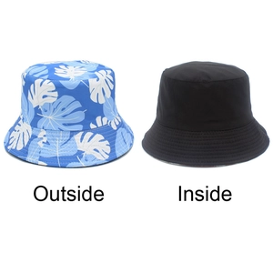 Dual-sided bucket hat with blue tropical leaf print and solid black reverse side view