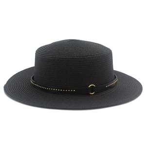Detail view of a black straw boater hat with a metallic studded leather belt and gold buckle