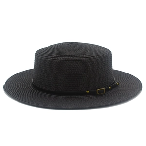 Detail of black straw boater hat with leather band and metallic buckle detail
