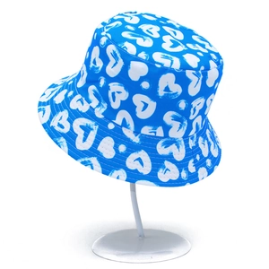 Blue cotton bucket hat with white heart graffiti pattern for outdoor sun protection