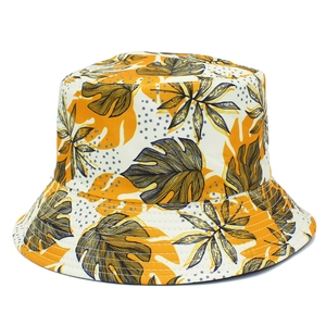 Detail of tropical plant leaf patterns and reinforced stitching on reversible bucket hat