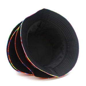 Close-up of double-sided bucket hat with rainbow tie-dye pattern and black lining details