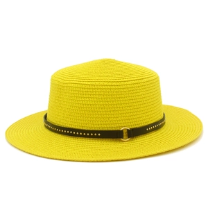Detailed close-up of yellow straw boater hat featuring a black belt with gold rivets