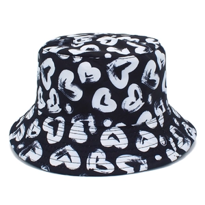 Stylish bucket hat in black with white hand-drawn heart patterns for women