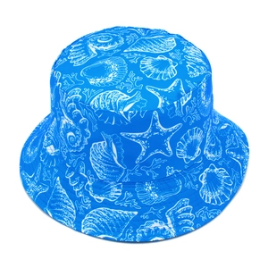 Detailed view of the bright blue fisherman hat with white sea shell and starfish patterns