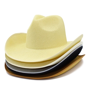 Detailed weave texture of stacked woven straw cowboy hats in assorted summer colors