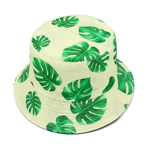 Detailed macro of tropical monstera leaf print on a reversible sun bucket hat