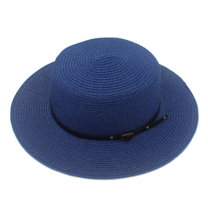 Detailed view of dark blue straw boater hat featuring a black leather band and gold buckle