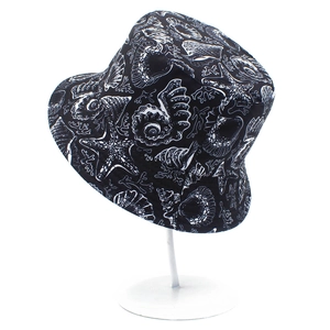 Close-up of ocean-themed marine life prints like shells and starfish on canvas bucket hat