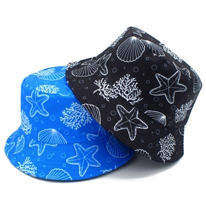 Top view of reversible bucket hats with starfish and sea shell prints in blue and black
