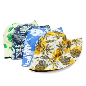 Detail showing various tropical palm leaf prints on reversible bucket hats with wide brims