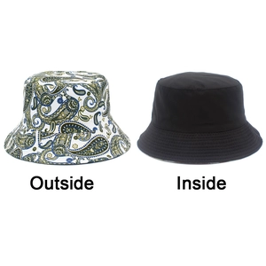 Detail of reversible bucket hat showing paisley pattern outside and solid black inside