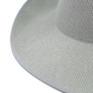 Close-up of light gray woven texture and fine stitching on a vintage fedora brim